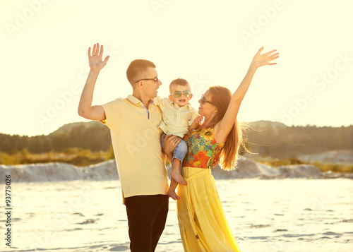 Happy beautiful family on the beach sunset