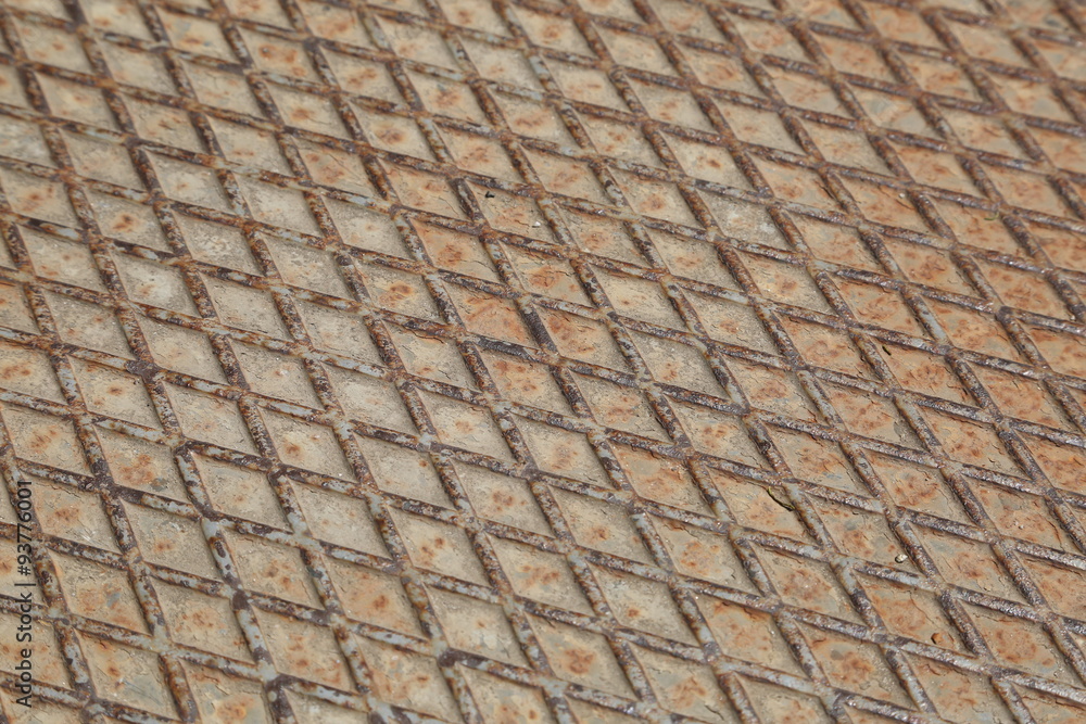 Rusty metal manhole diagonal pattern. Metal texture