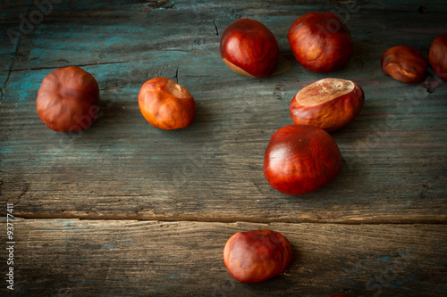 ripe chestnuts on a wooden background