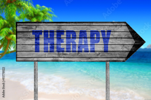 Therapy wooden sign with a beach on background