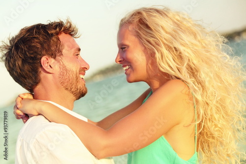 Romantic couple in love kissing happy at beach