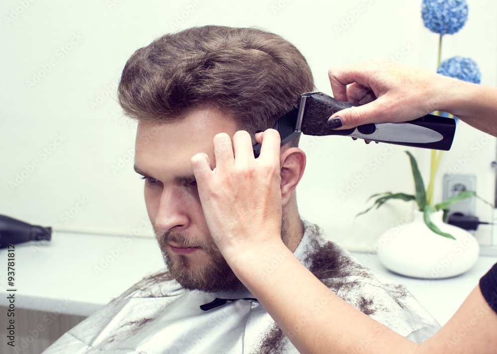 Fototapeta premium The young man at the hairdresser salon hairstyle make model