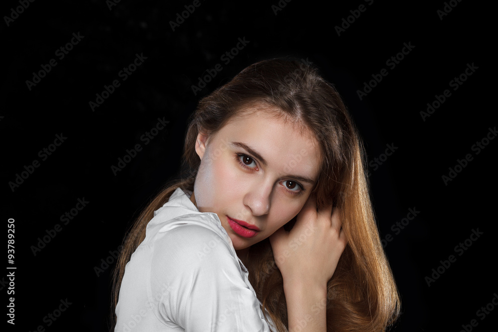 Young casual woman isolated over black background