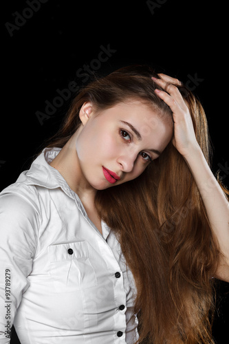 Young casual woman isolated over black background