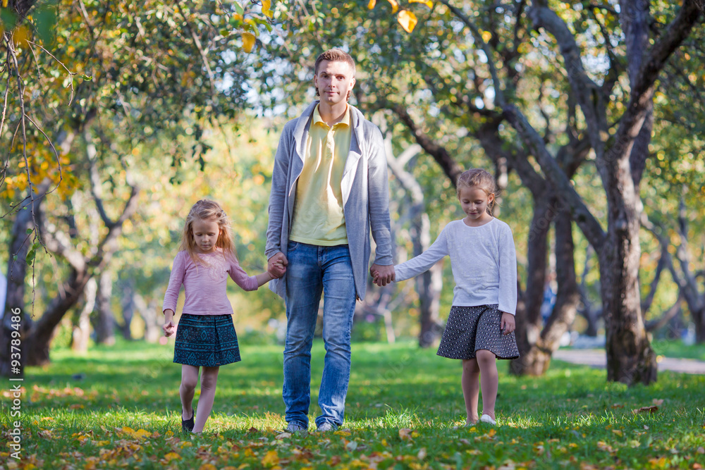 Obraz premium Happy family of three in autumn park outdoors