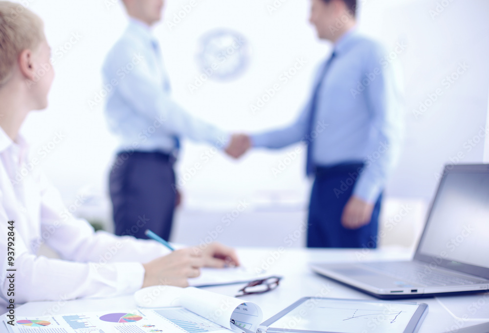 Business people shaking hands, finishing up a meeting, in office Business people shaking hands, finishing up a meeting, in office