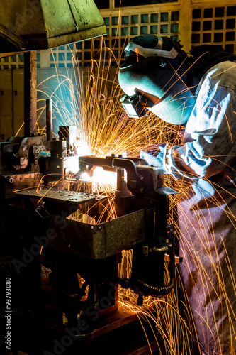 sparks while welder uses torch to welding