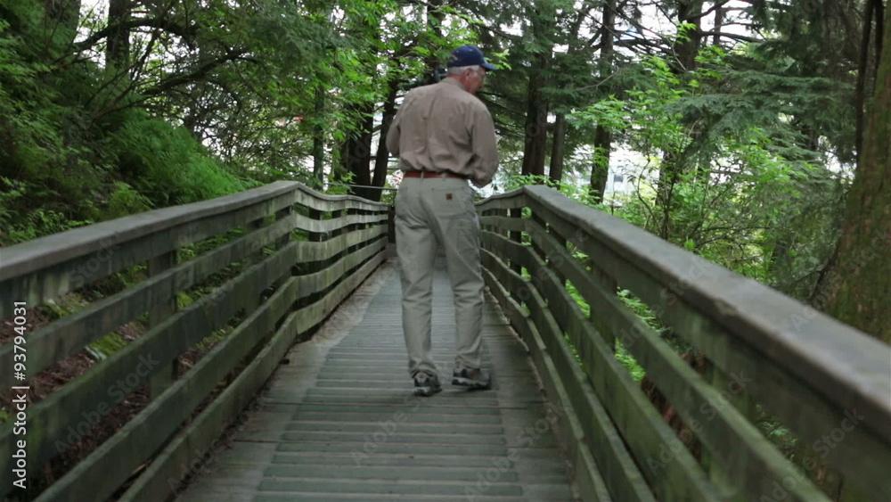 Man photographer on nature boardwalk Ketchikan Alaska HD 7547 Man photographer on nature boardwalk Ketchikan Alaska HD 7547