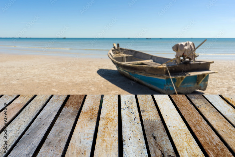 Wood table top on blurred sea and Boat background - can be used