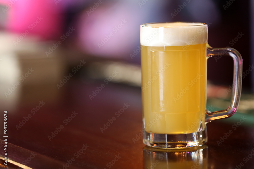 Cold beer glass on bar or pub desk Cold beer glass on bar or pub desk