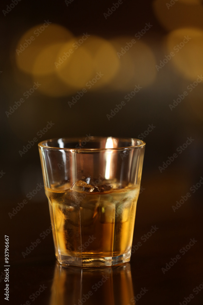 Whiskey glass tumbler standing on bar counter Whiskey glass tumbler standing on bar counter