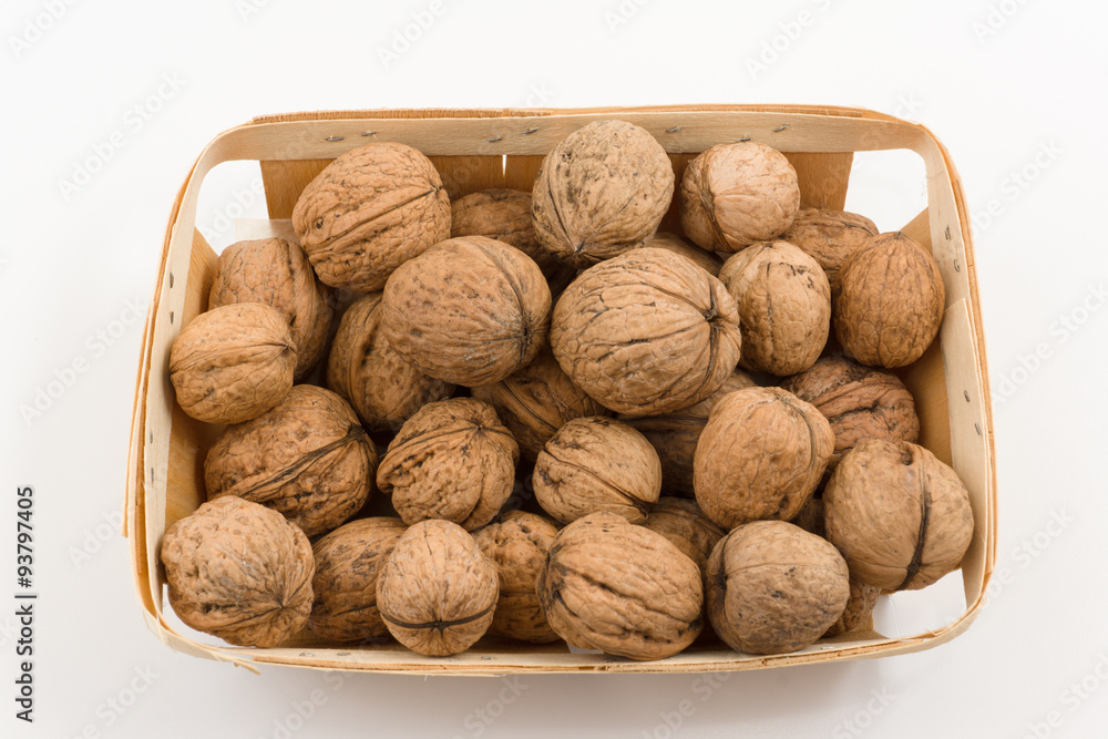 wooden container is filled with a walnut on a white background