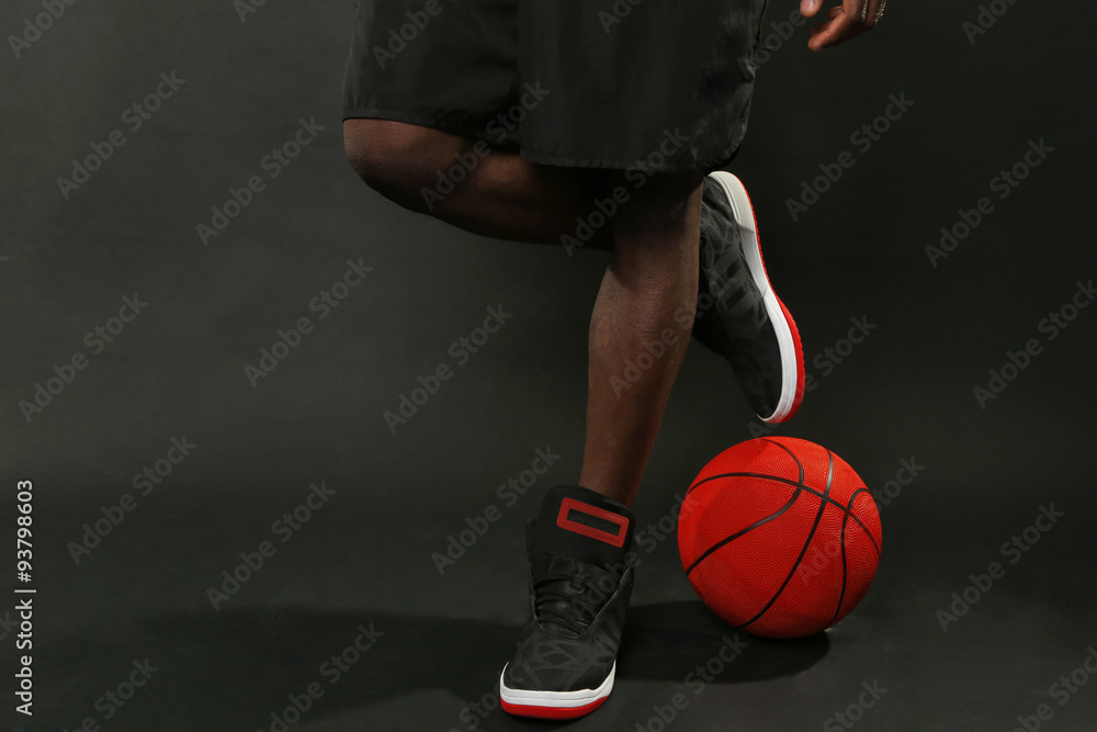 African American basketball player with ball on dark background African American basketball player with ball on dark background