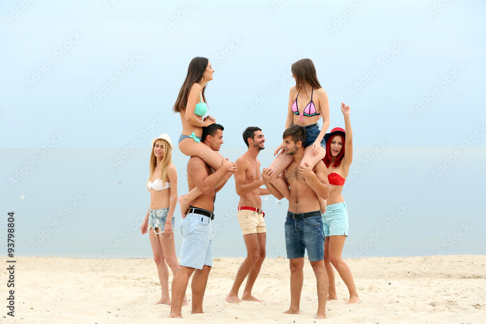 Beautiful young people having fun on beach