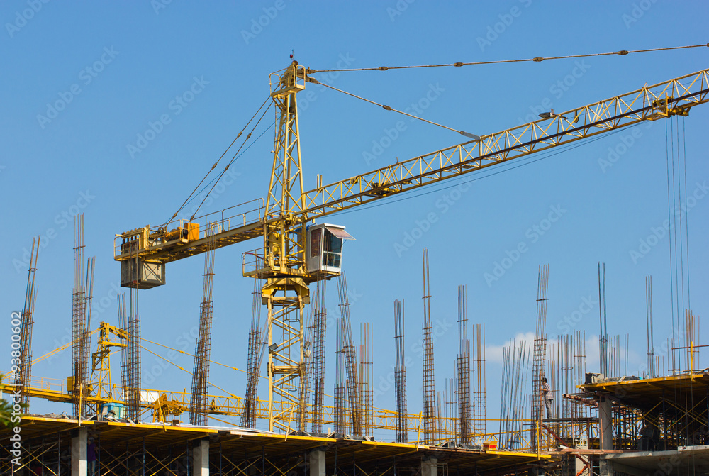 Construction site with crane isolated on blue sky. Construction site with crane isolated on blue sky.