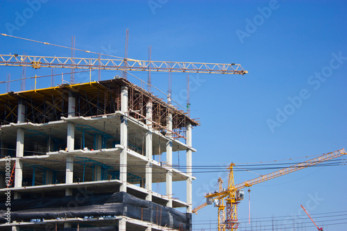 Construction site with crane isolated on blue sky.