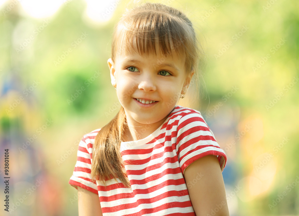 Little happy girl playing in park near the playground Little happy girl playing in park near the playground