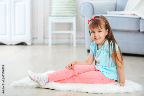 Little cute girl sitting on...