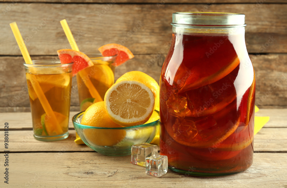 Iced tea with lemon and grapefruit on wooden background Iced tea with lemon and grapefruit on wooden background
