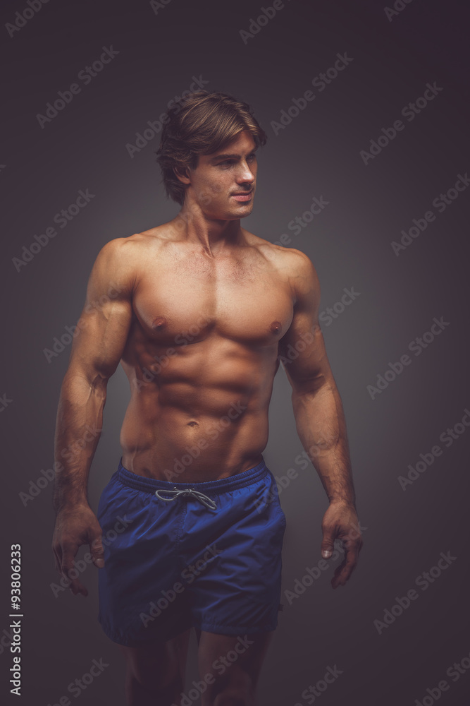 Fototapeta premium Shirtless muscular man in blue shorts.