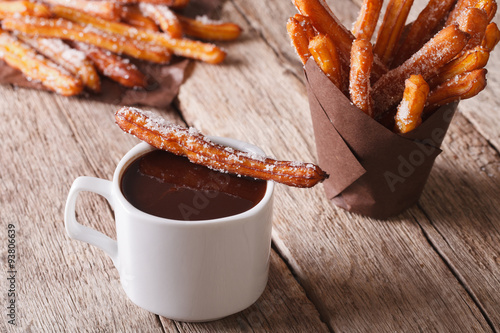 Spanish cuisine: churos and hot chocolate on the table. horizontal
