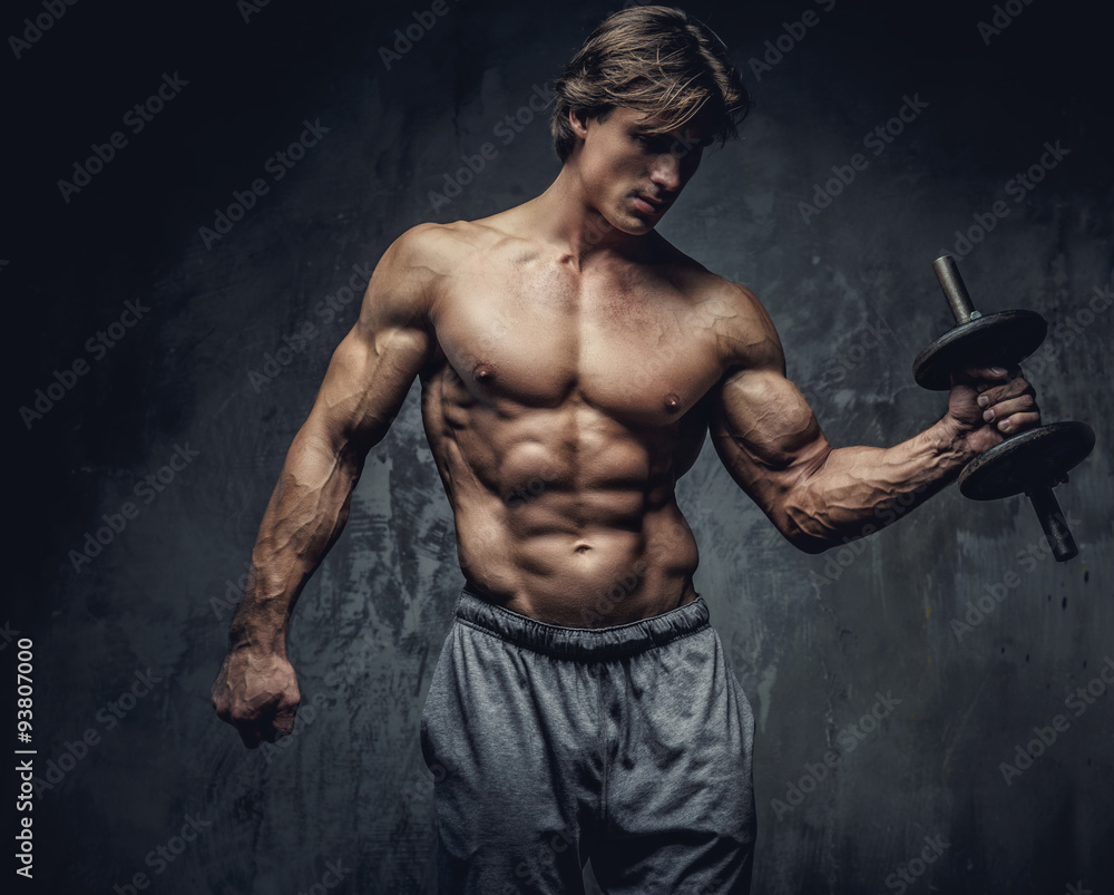 Shirtless bodybuilder holding dumbell.