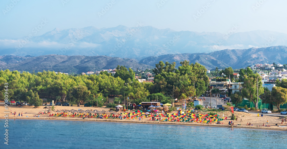 Fototapeta premium Tropical beach with deckchairs, umbrellas and people.