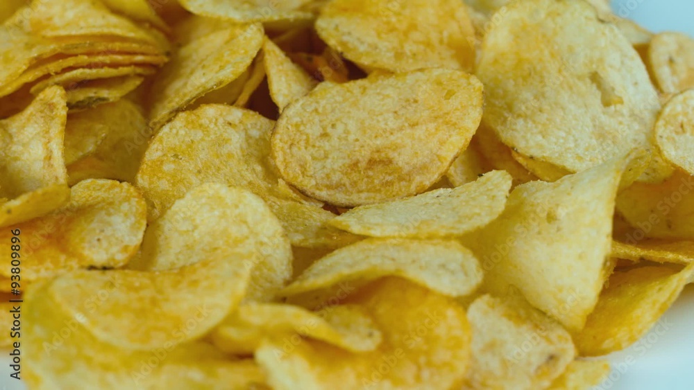 Potato chips are rotated in front of camera Potato chips are rotated in front of camera