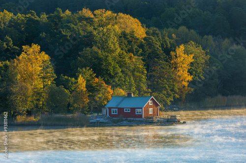 House on the coast with the autumn forest