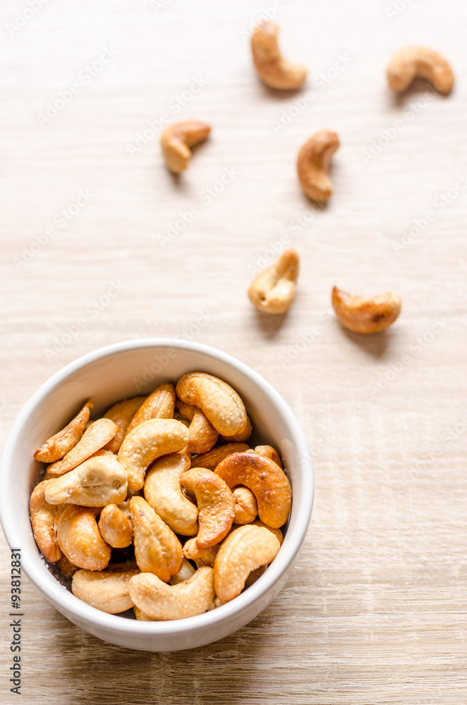 Close up cashew nuts on wooden background Close up cashew nuts on wooden background