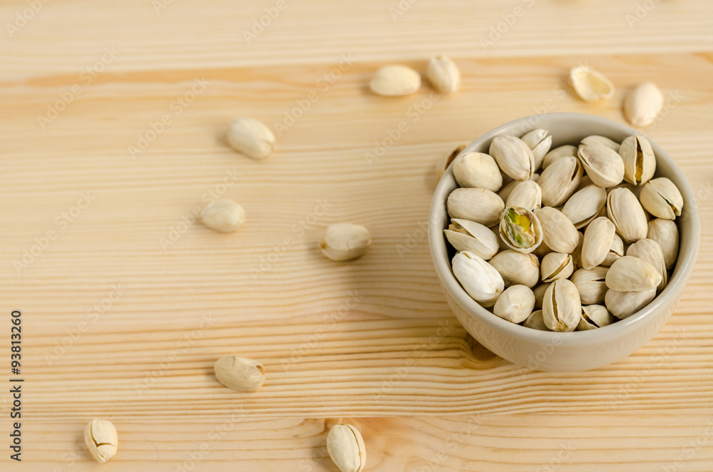 Pistachios Nuts on wooden background Pistachios Nuts on wooden background
