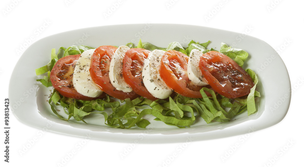 Italian salad - Caprese salad, tomato and mozzarella with spices, served on a white plate. Isolated on white. Italian salad - Caprese salad, tomato and mozzarella with spices, served on a white plate. Isolated on white.