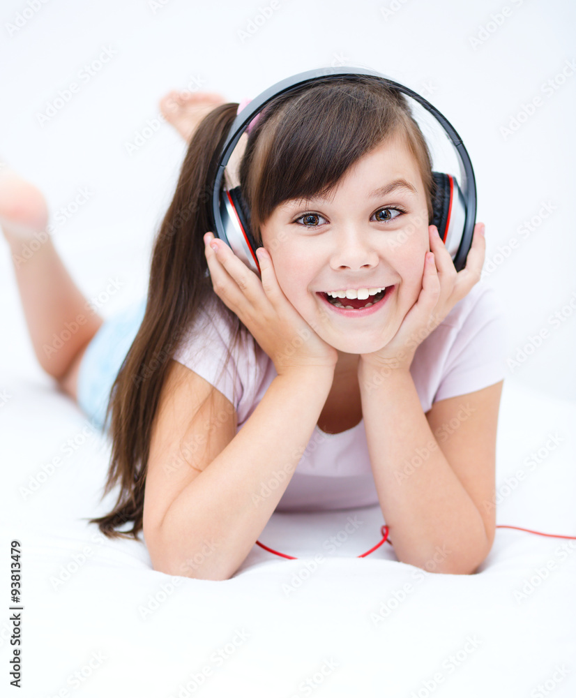 Girl is enjoying music using headphones Girl is enjoying music using headphones