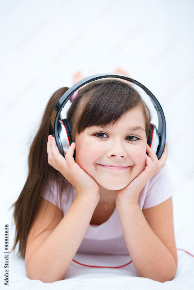 Girl is enjoying music using headphones Girl is enjoying music using headphones