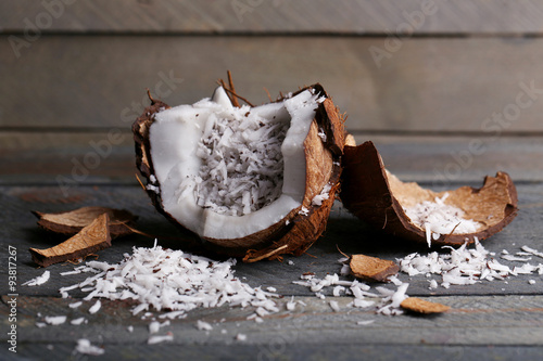 Coconut shavings in coconut on wooden background