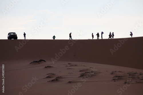 Photo of sand dunes with travellers, Silhuette