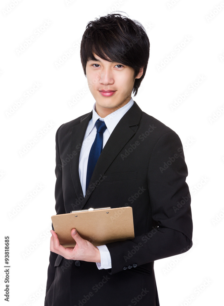 Asian Young businessman hold with file board Asian Young businessman hold with file board