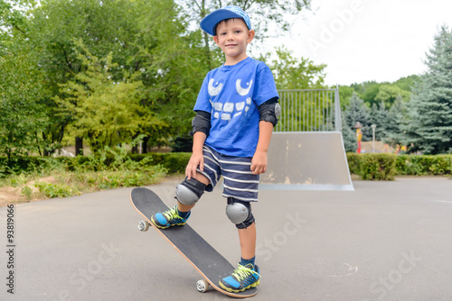 Happy boy practicing balancing on a skateboard photo