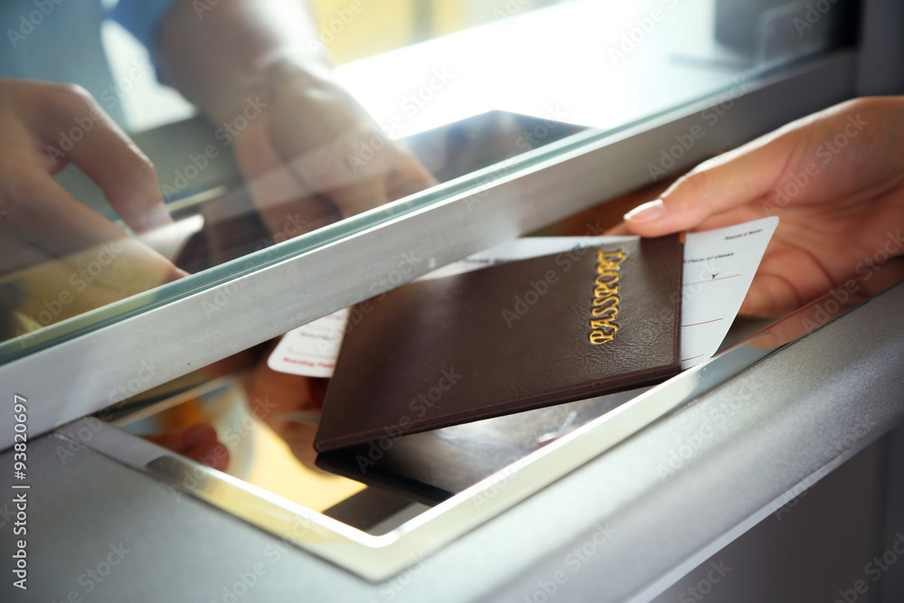 Obraz premium Woman buying tickets with passport at box office