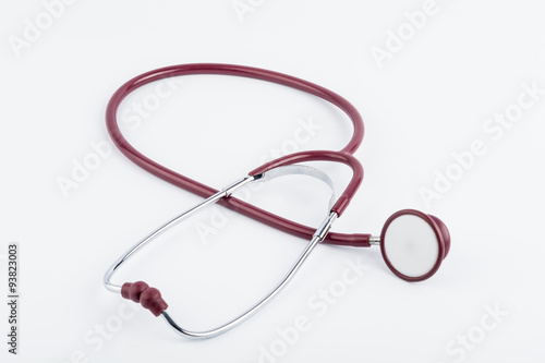 Red stethoscope medical equipment on white background