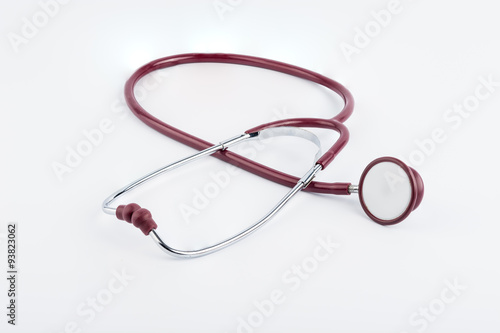 Red stethoscope medical equipment on white background