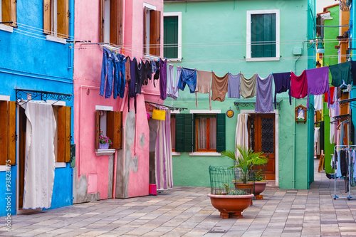 small yard on Burano's island with multi-colored houses and the linen hanged on a rope © Shchipkova Elena