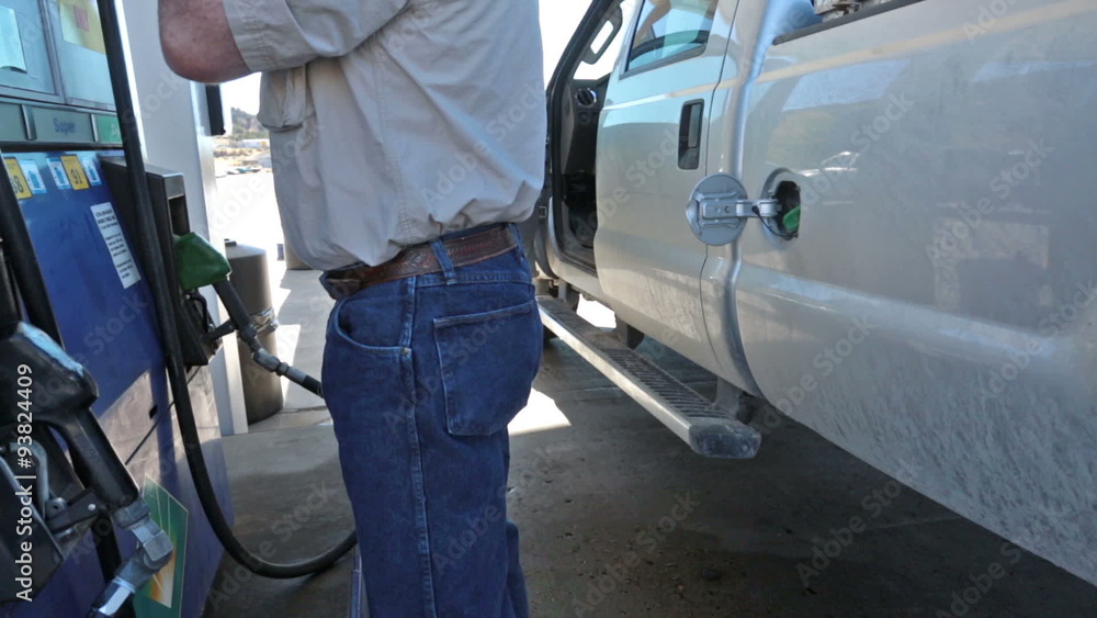 Man filling gas into pickup truck HD 3525 Man filling gas into pickup truck HD 3525