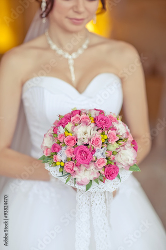 Beautiful bride in autumn forest with bouquet 