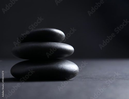 Balanced pebbles on dark background