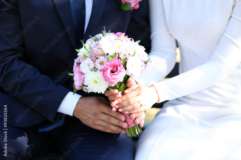 Bride and groom holding wedding bouquet Bride and groom holding wedding bouquet