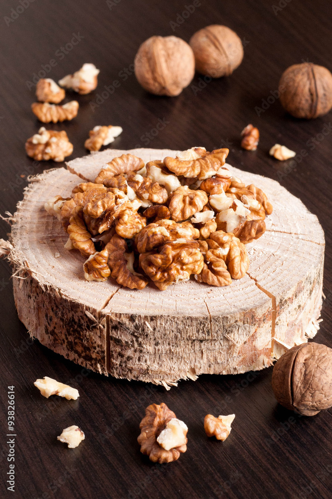 Walnut kernels and whole walnuts on wooden table Walnut kernels and whole walnuts on wooden table