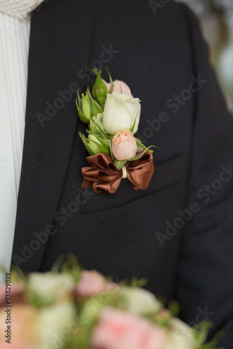 Boutonniere on trendy groom at wedding photo