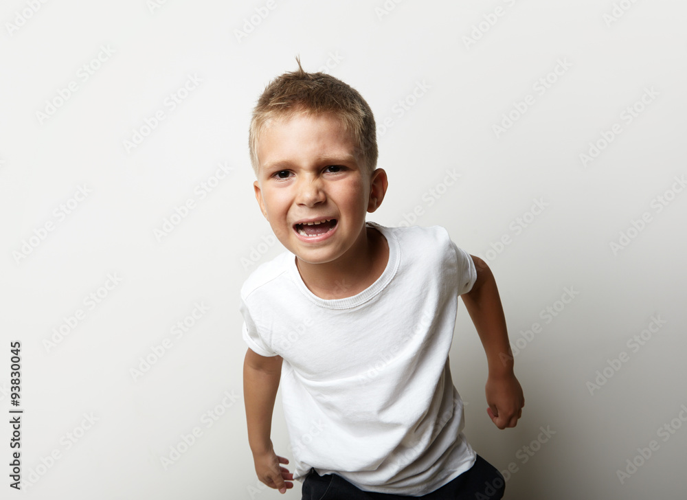 Portrait of a boy in white t-shirt. He is very upset and ready Portrait of a boy in white t-shirt. He is very upset and ready