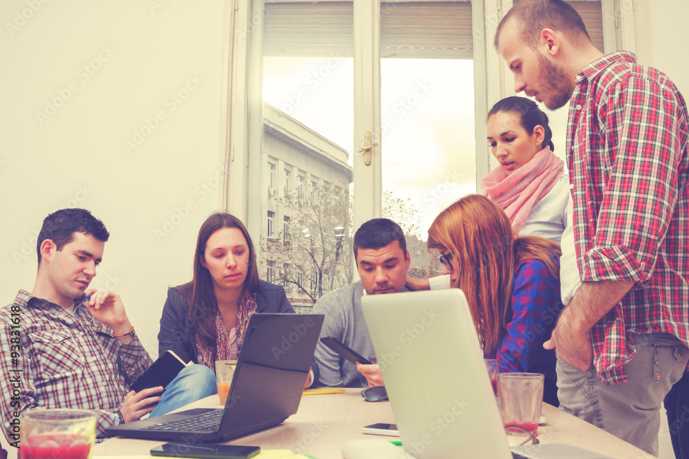 Young group of people discussing business plans. Young group of people discussing business plans.